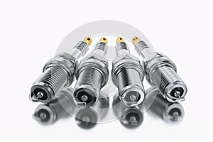 Spare parts spark plugs on white background for car and motorcycle