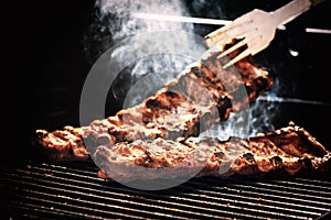 Spare ribs cooking on barbecue grill for summer outdoor party. F photo