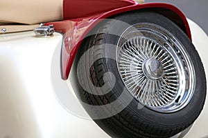 spare tire with chrome rim of an ancient vintage car