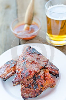 Spareribs on grill with hot marinade, czech beer