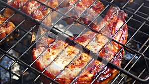 Spareribs on the grill. Summer barbecue concept.