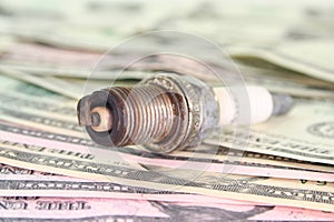 Spark plug on dollar bills