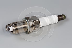 Spark plug for petrol internal combustion engine on gray background