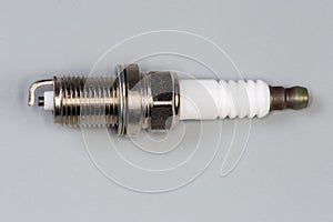 Spark plug for petrol internal combustion engine on gray background