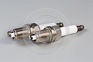 Spark plugs for petrol internal combustion engine on gray background