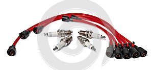 Spark plugs and red wires of a high pressure. Car parts.