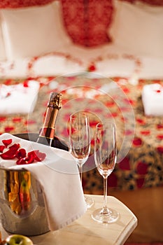 Sparking wine, champagne glasses and rose petals