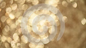 Sparkle glittering background. Holiday abstract texture. Christmas card with gold bokeh, defocused lights.