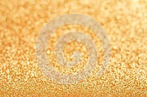 Golden blured shiny glitter texture background .