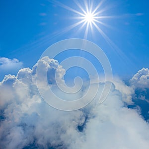 sun above a dense cumulus clouds