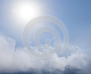 Sparkle sun above a dense cumulus clouds