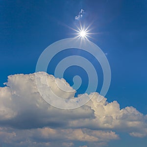 Sparkle sun above dense cumulus clouds