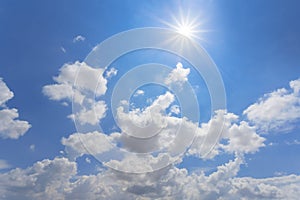 Sparkle sun on blue cloudy sky background