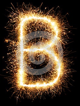 Sparkler firework light alphabet B on black