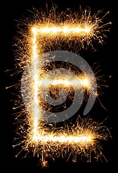 Sparkler firework light alphabet E on black