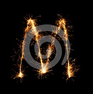 Sparkler firework light alphabet M (Capital Letters) at night