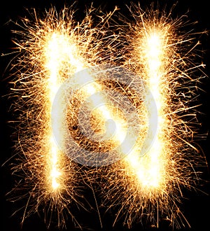 Sparkler firework light alphabet N on black
