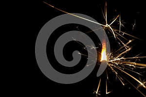 Extreme close-up of a burning sparkler with black background photo