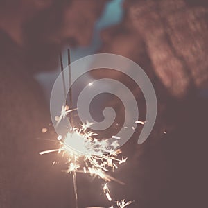 Sparkler light and romantic celebration for couple in love in background. Focus on fire. Romance and relationship concept. New