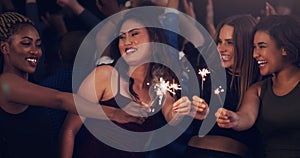 Sparkler, party and night with women in club for music, celebration and nightlife concert. Festival, disco and happy