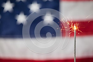 Sparklers burning against American flag background