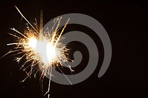 Sparklers in the dark. Sparks with fire in hands on a stick. Awesome