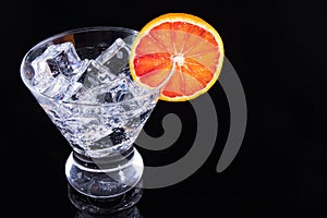 Sparkling beverage in a martini glass with a blood orange slice