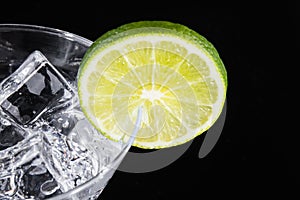 Sparkling beverage in a martini glass with a lime slice