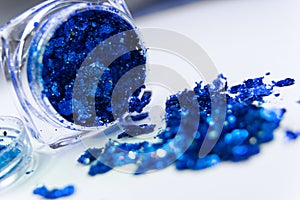 Sparkling blue glitter in a makeup jar