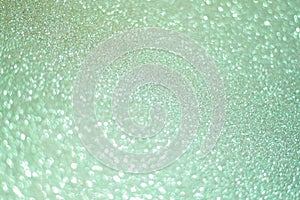 Sparkling bokeh background in a fresh emerald color. turquoise sequins background
