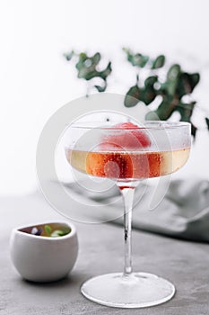 sparkling champagne cocktail with strawberry sorbet