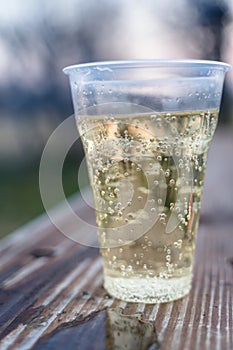 Sparkling Champagne in Plastic Cup, Concept of Alcoholism and Loneliness