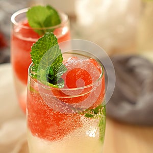 Sparkling cocktail with watermelon and melon ball-shaped pieces and ice