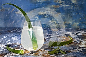 Sparkling cucumber mint gin and tonic fizz with aloe vera on marble table. Copy space. Dragon tail cocktail for fans party.