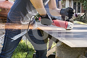 Sparkling lights of work with angle grinder machine - cutting metal