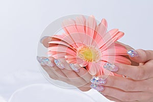Sparkling manicure with pink flower
