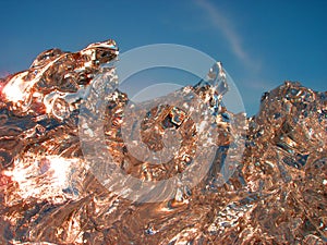 Sparkling melting ice  background with frosty pattern and sun light