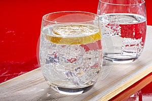 Sparkling mineral drink water in glasses served on table with le