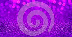 Sparkling purple magenta glitter background with bokeh. Closeup view, dof. Pattern with shining fine purple sequins. Festive