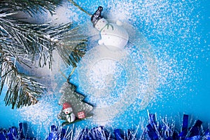 Sparkling Red Christmas Bauble on Snow-Covered Pine Tree With Copy Space