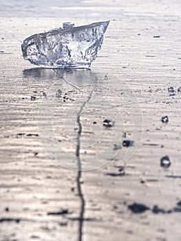 sparkling shards of cracked ice jut out on the frozen lake. The light effect occurs
