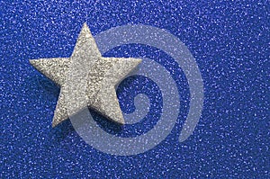 Sparkling silver star in brilliant golden background