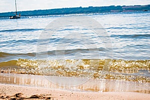 Sparkling silver waves in the sand. Summer beach background with a space for text