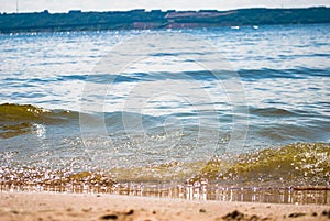 Sparkling silver waves in the sand. Summer beach background with a space for text