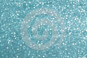 Sparkly glitter, turquoise background bokeh effect photo