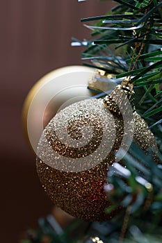 Sparkly gold Christmas baubles on tree