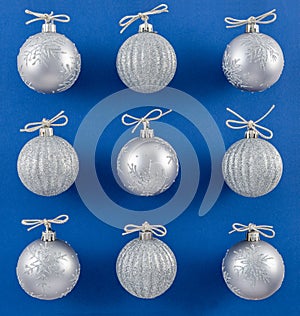 Sparkly Silver Ornaments on Vibrant Blue Background