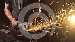 Sparks during cutting of metal angle grinder. Worker using industrial grinder.