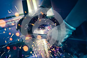 Sparks during cutting of metal part grinder