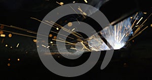 sparks from electric arc welding at construction site.